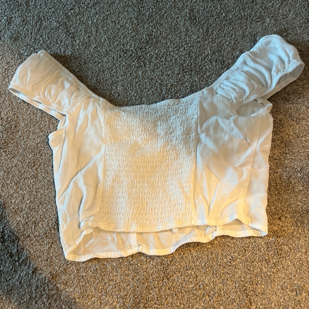 Small white cropped top, stretchy in the back, tie on the front